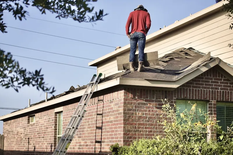 Professional roofer working on a residential roof in Holtville